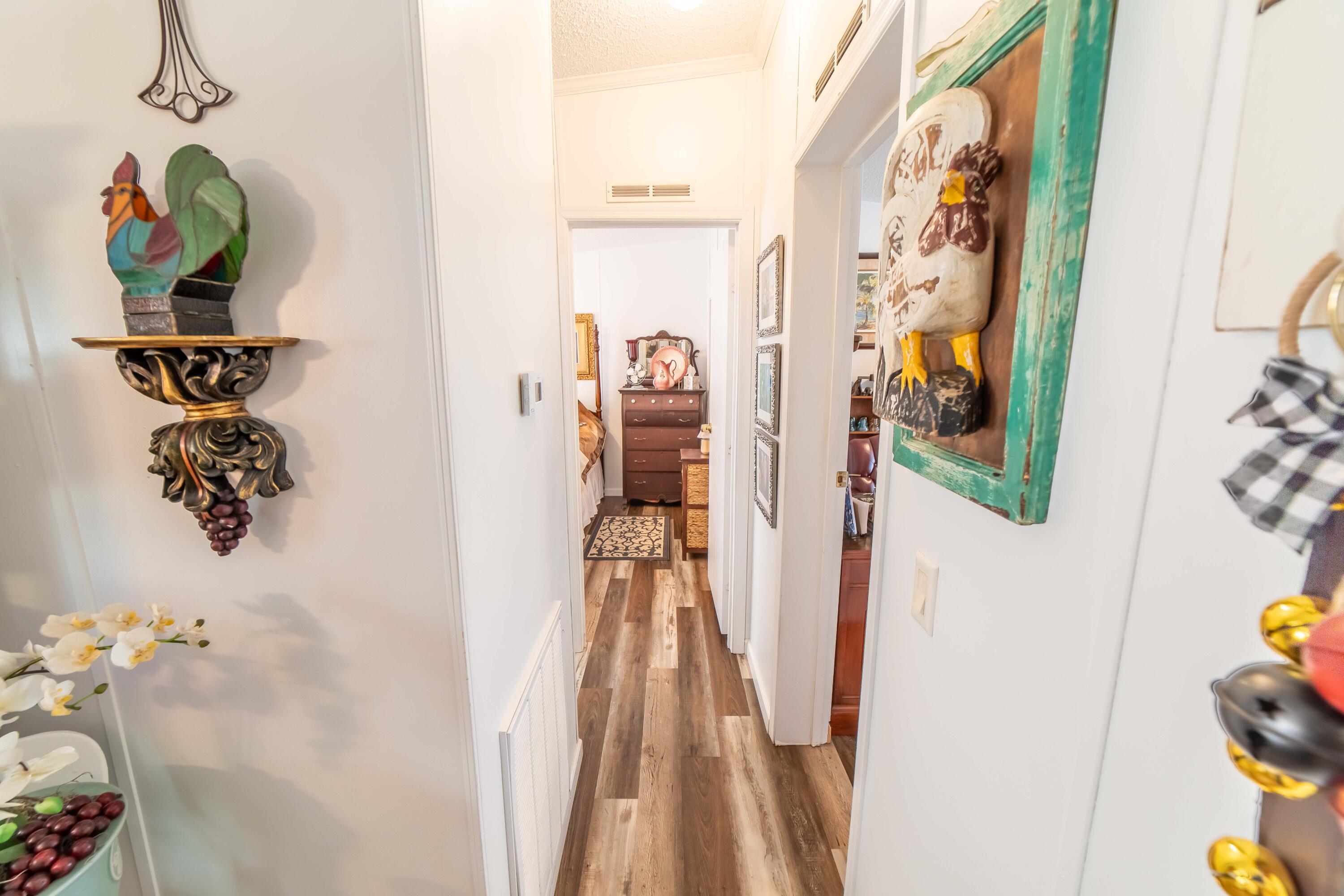 12302 Highway 441 Okeechobee, FL 34974 - Photo 31 of 63 a hallway with painting on the wall and a table