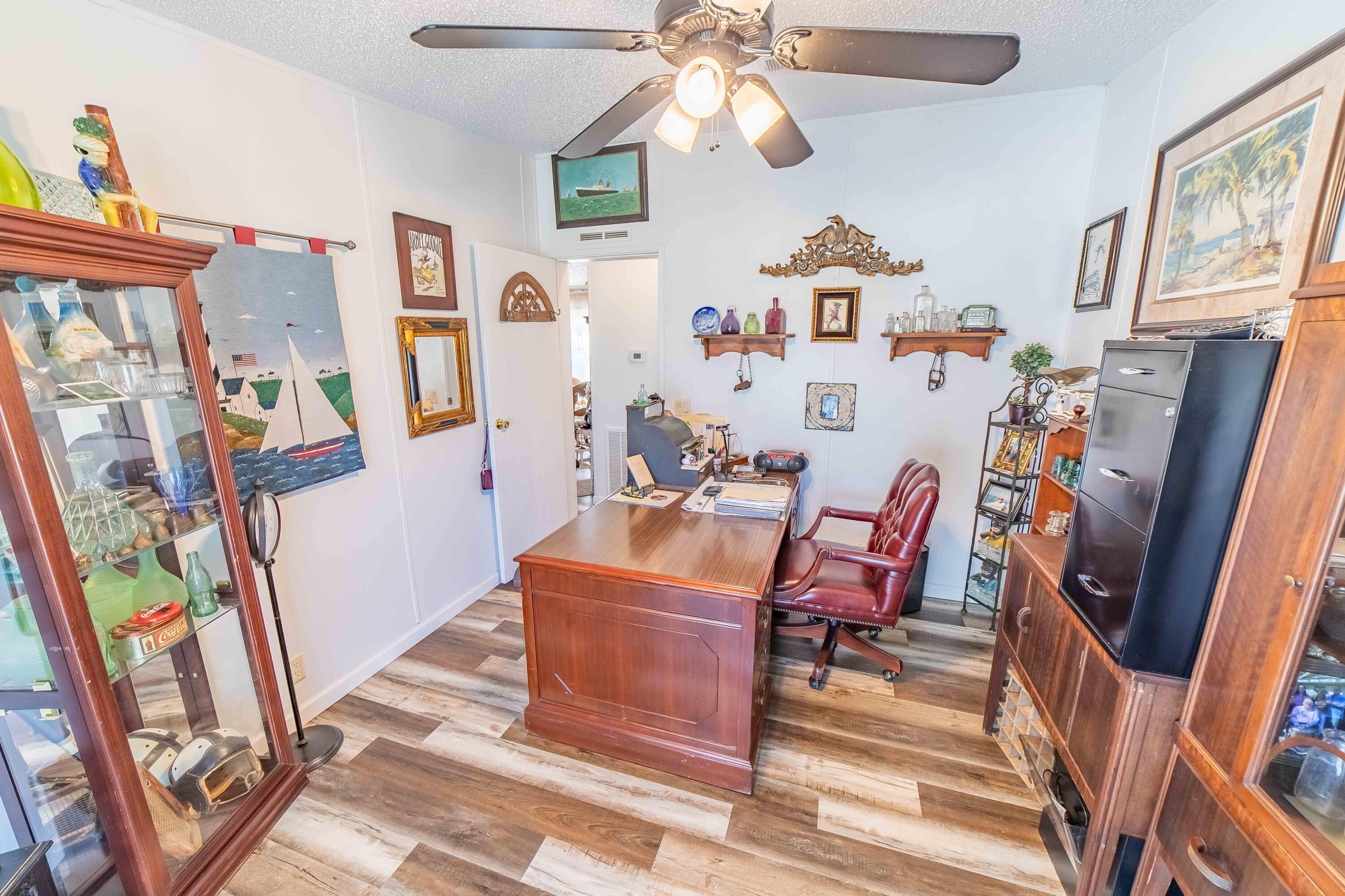 12302 Highway 441 Okeechobee, FL 34974 - Photo 33 of 63 a living room with furniture and a flat screen tv