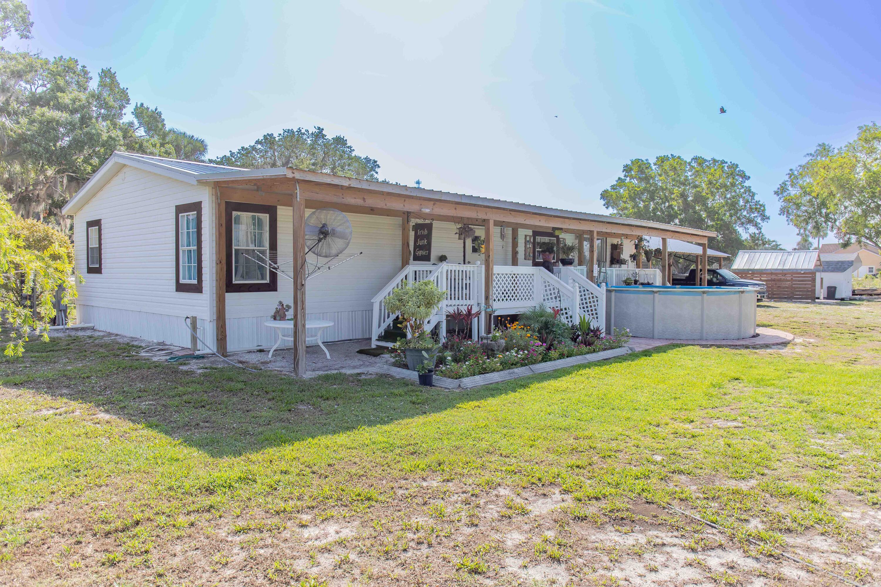 12302 Highway 441 Okeechobee, FL 34974 - Photo 42 of 63 a view of a house with backyard and sitting area