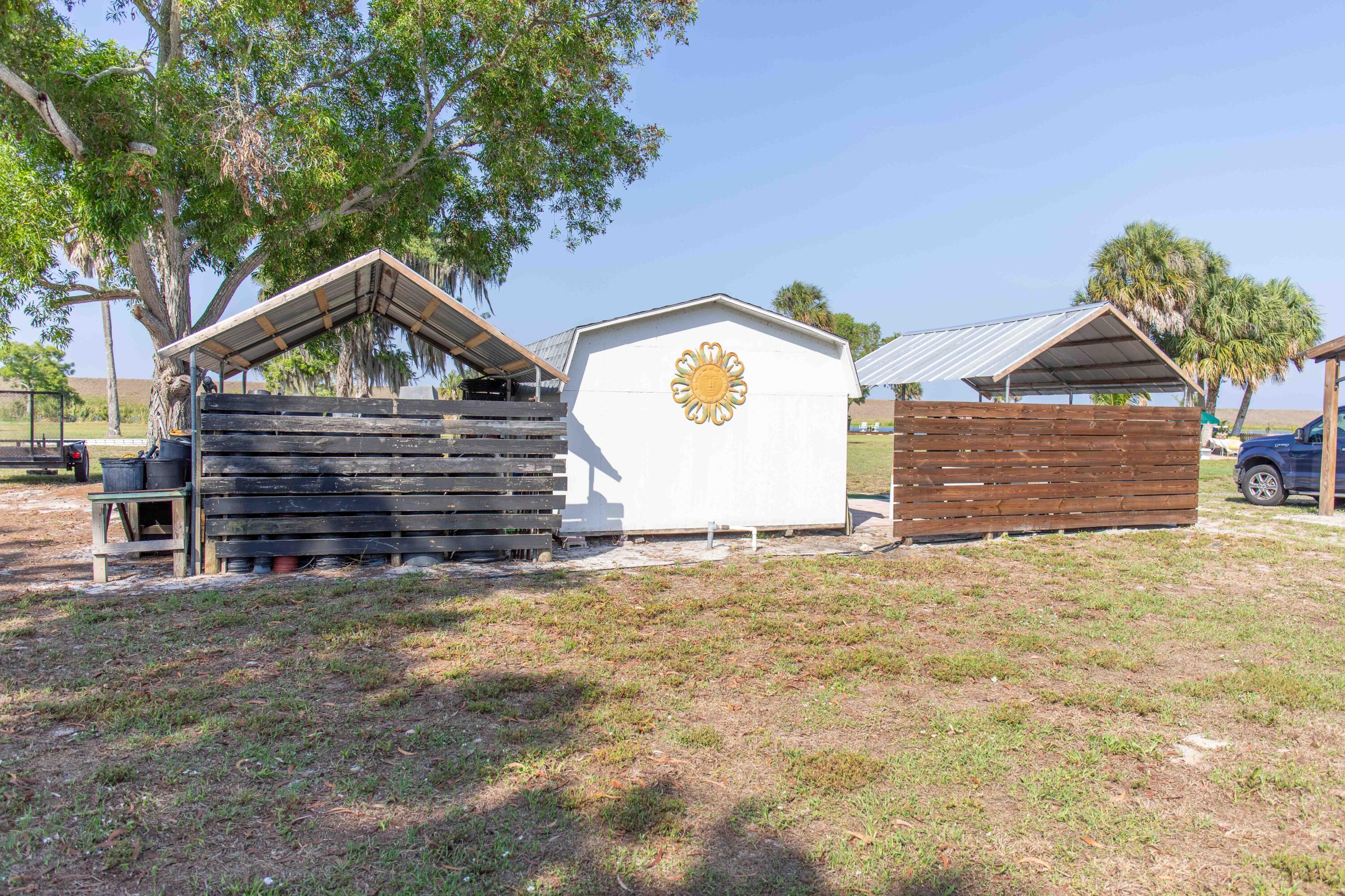 12302 Highway 441 Okeechobee, FL 34974 - Photo 43 of 63 a view of a house with a yard and garage