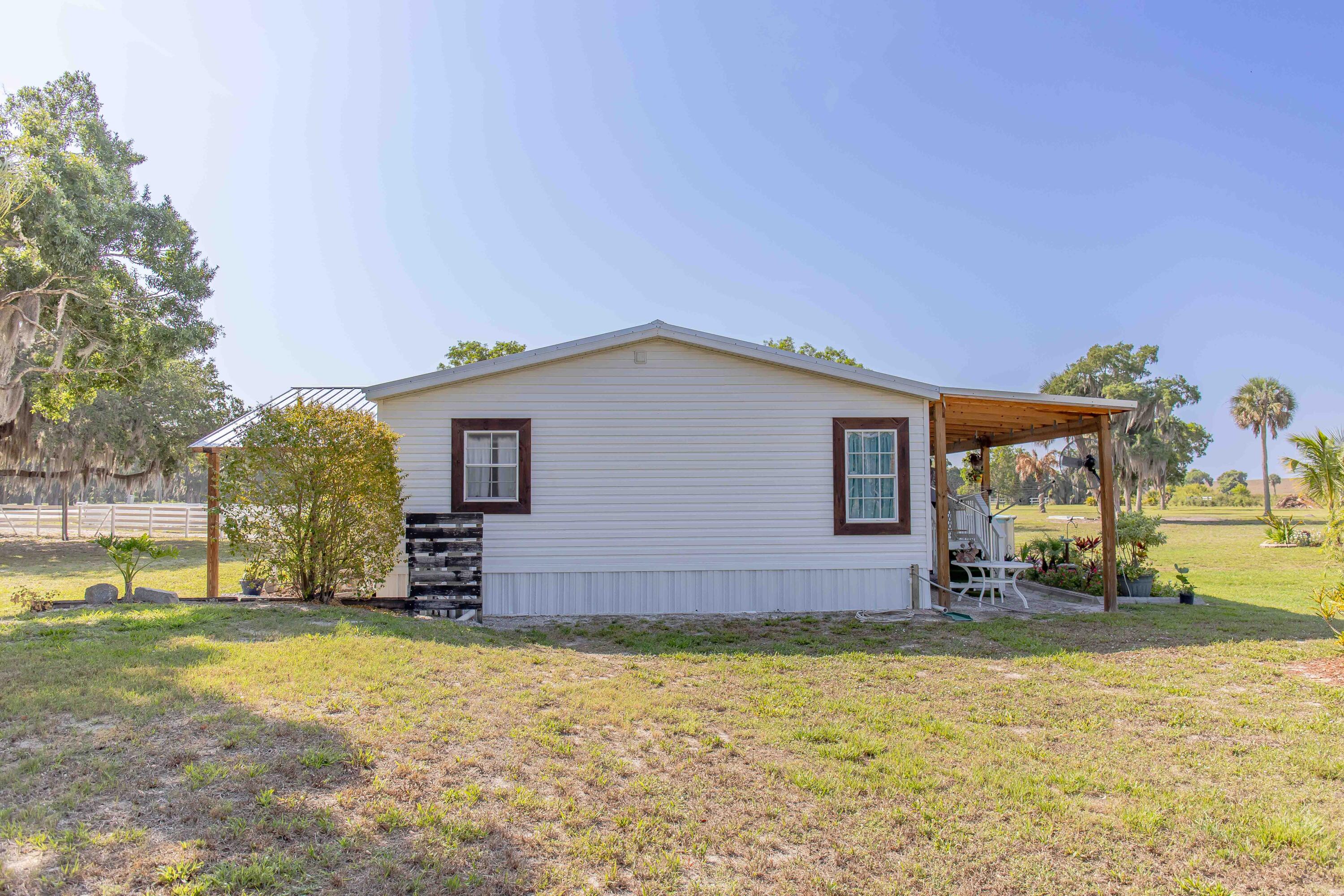12302 Highway 441 Okeechobee, FL 34974 - Photo 45 of 63 a view of a house with a yard