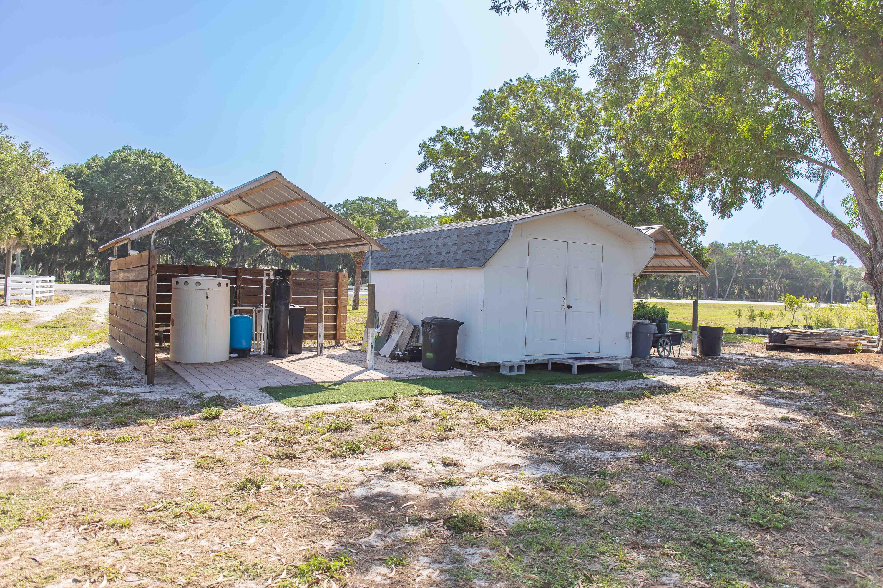 12302 Highway 441 Okeechobee, FL 34974 - Photo 49 of 63 a view of a house with backyard and a tree