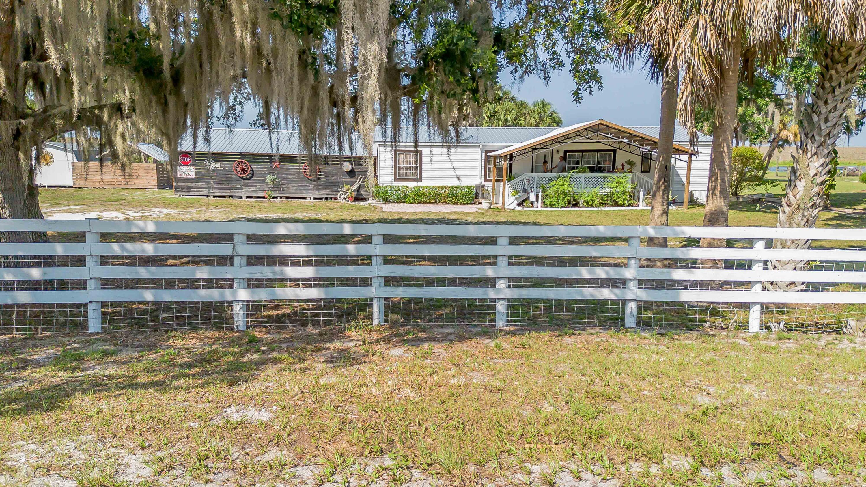 12302 Highway 441 Okeechobee, FL 34974 - Photo 54 of 63 a view of swimming pool with a house in the background
