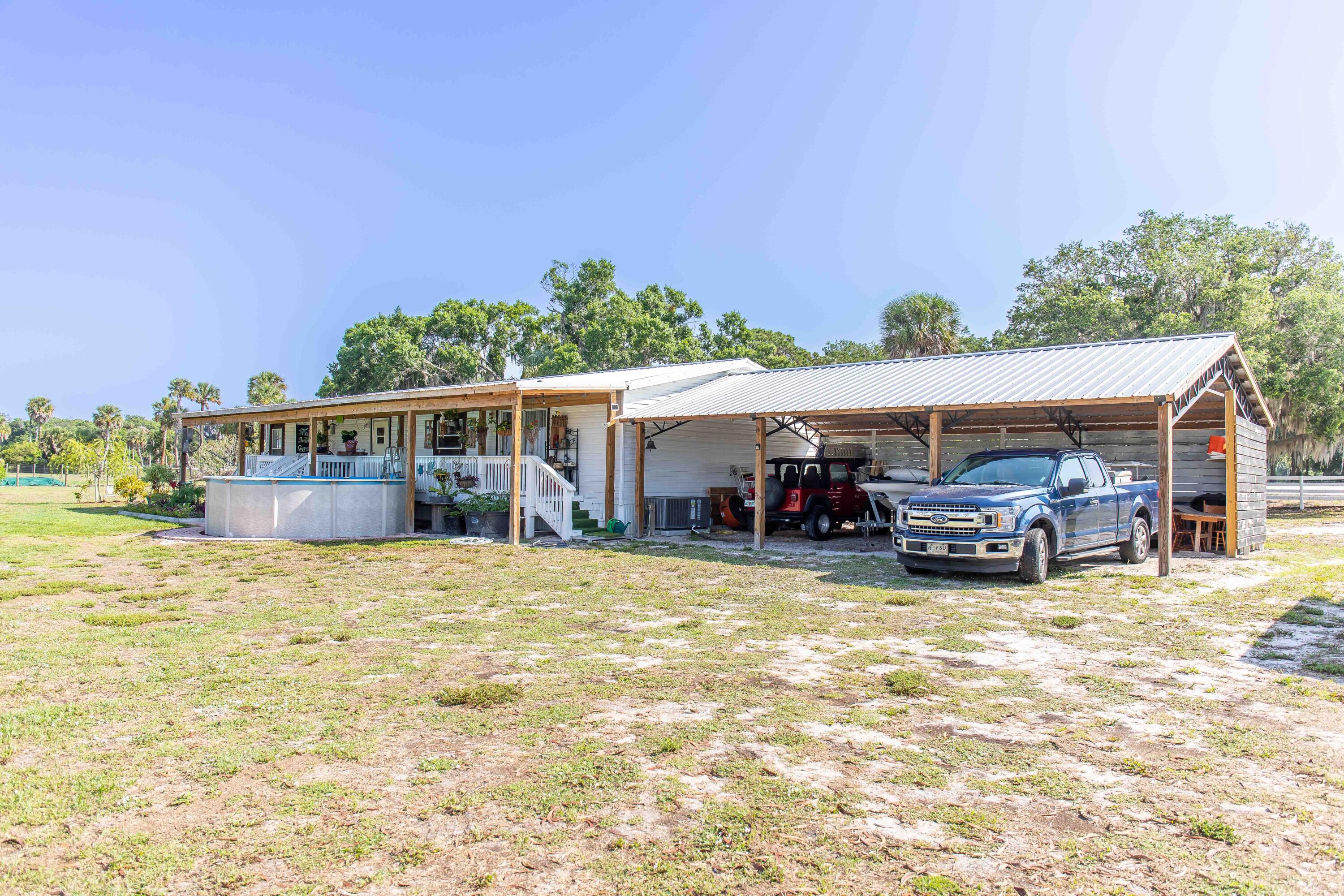 12302 Highway 441 Okeechobee, FL 34974 - Photo 56 of 63 a view of house with outdoor space and swimming pool