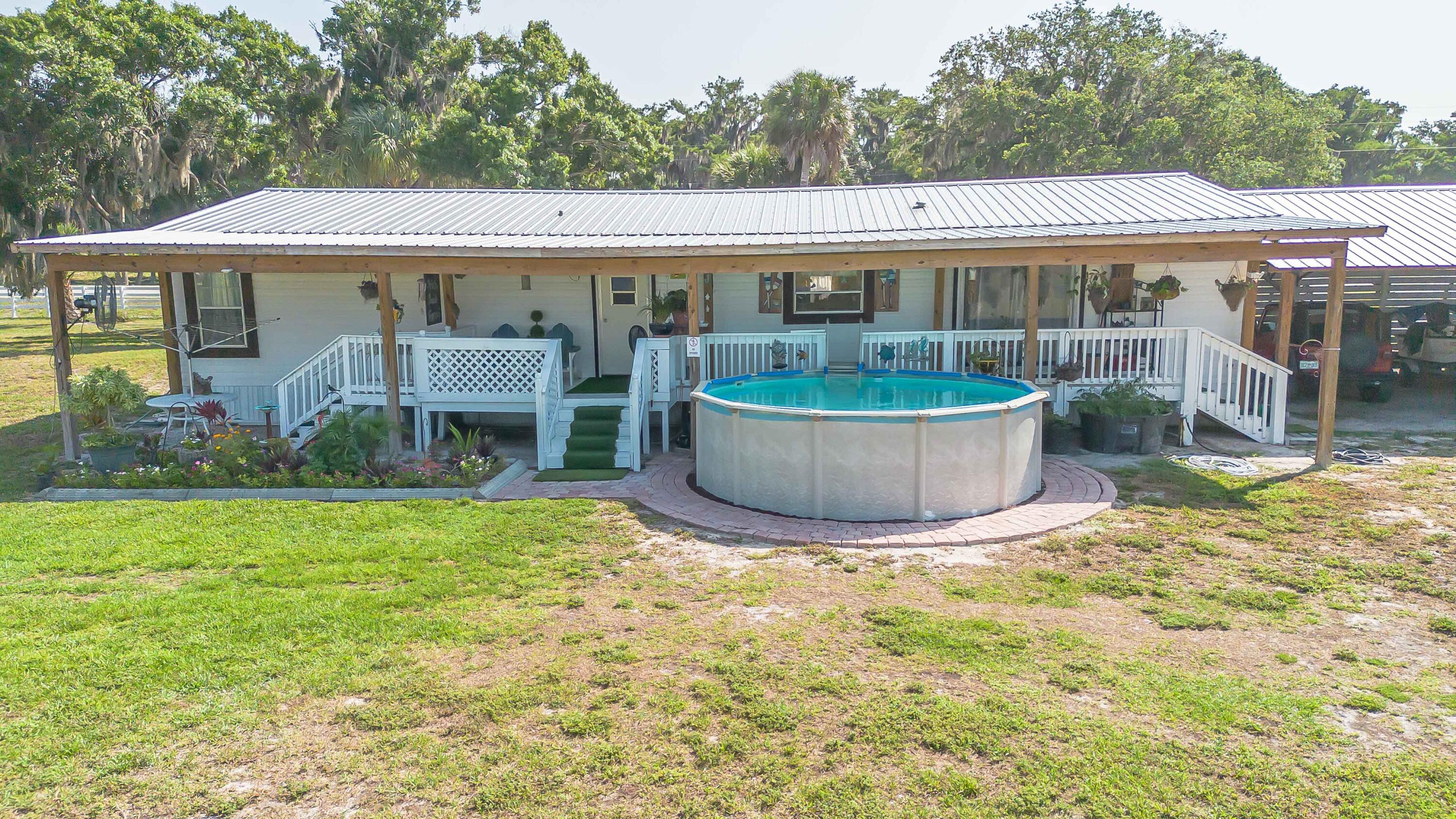 12302 Highway 441 Okeechobee, FL 34974 - Photo 59 of 63 a view of a house with backyard and sitting area