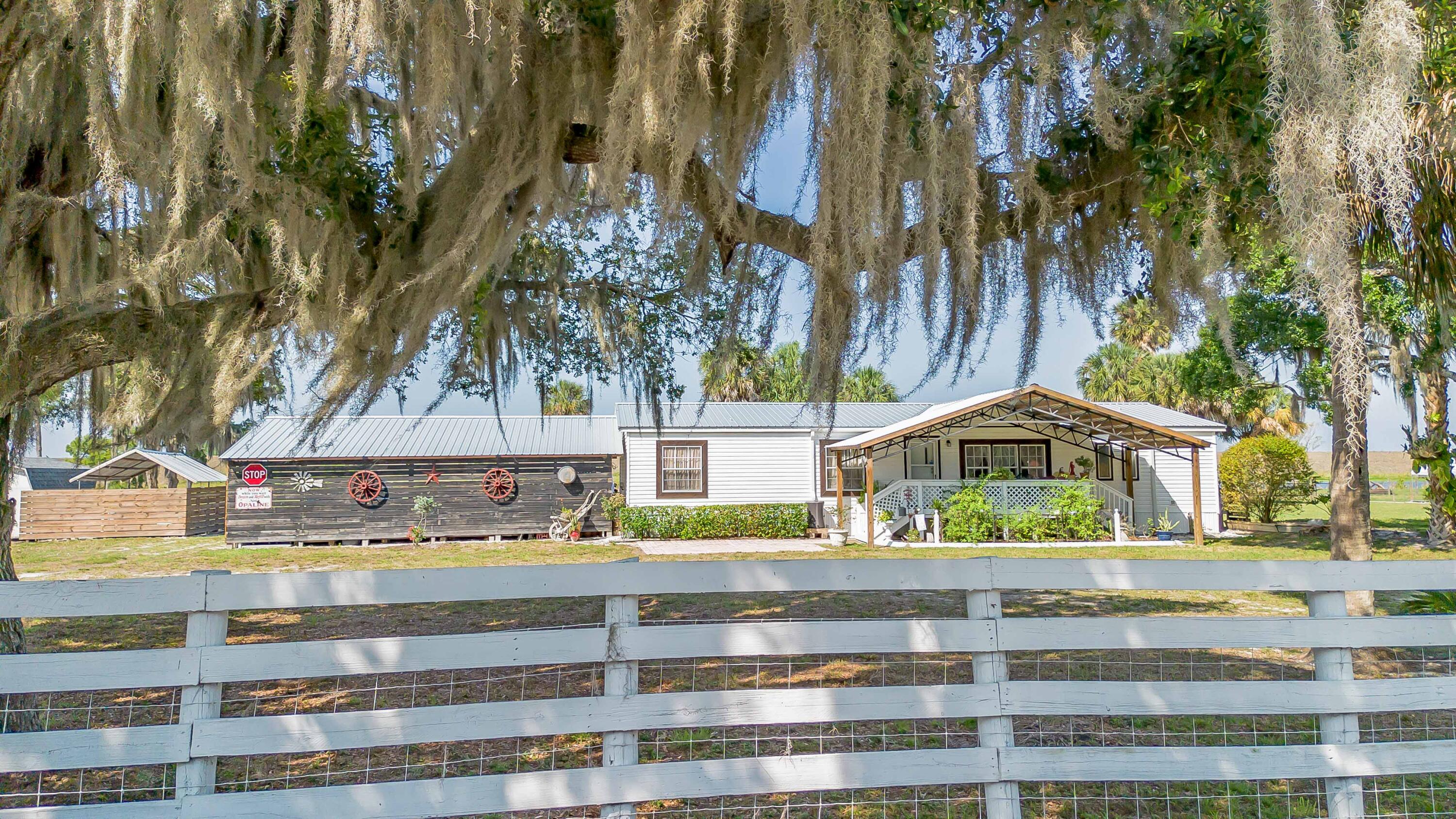 12302 Highway 441 Okeechobee, FL 34974 - Photo 62 of 63 a view of building with trees in front of it