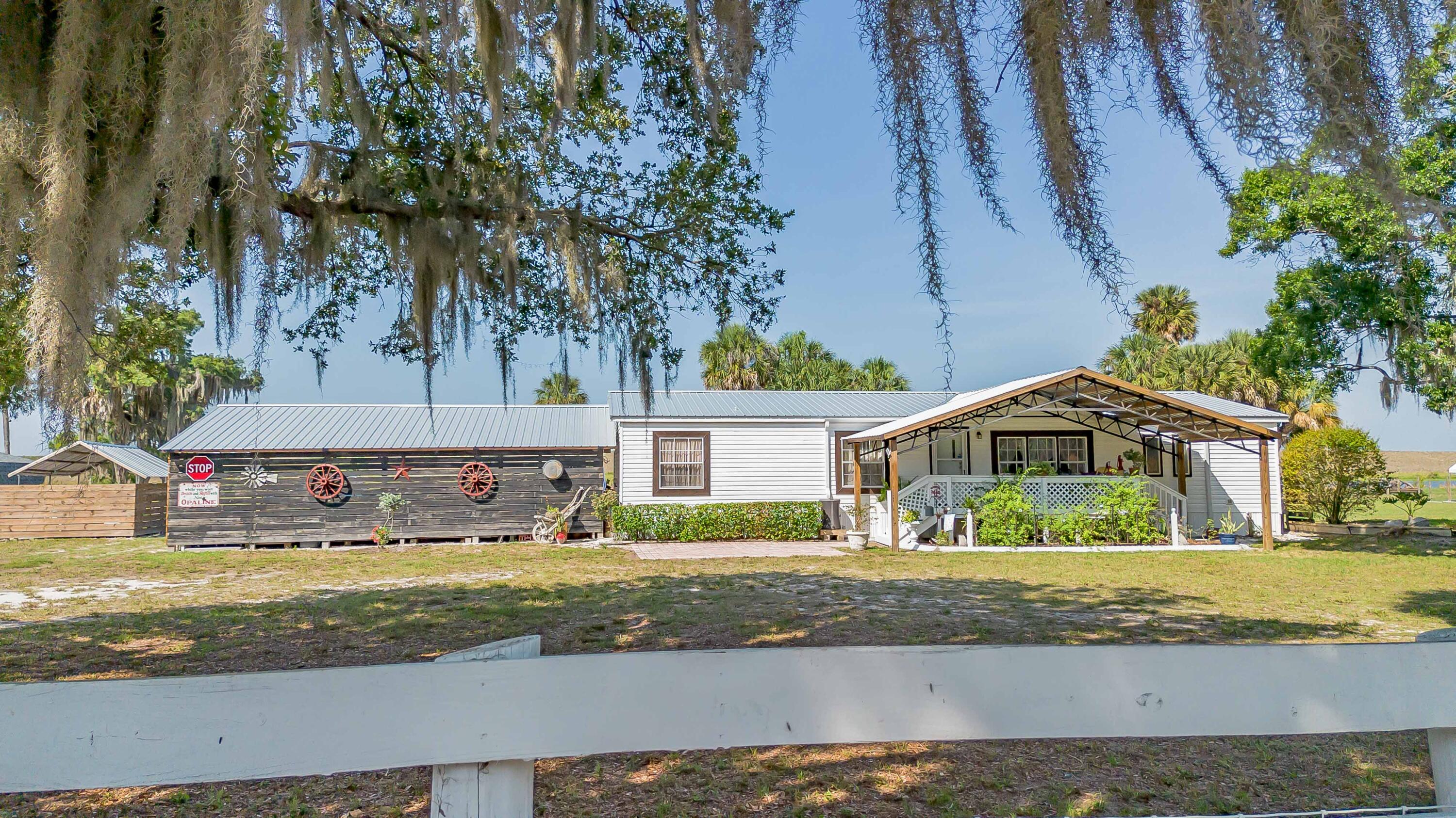 12302 Highway 441 Okeechobee, FL 34974 - Photo 63 of 63 a front view of a house with a yard