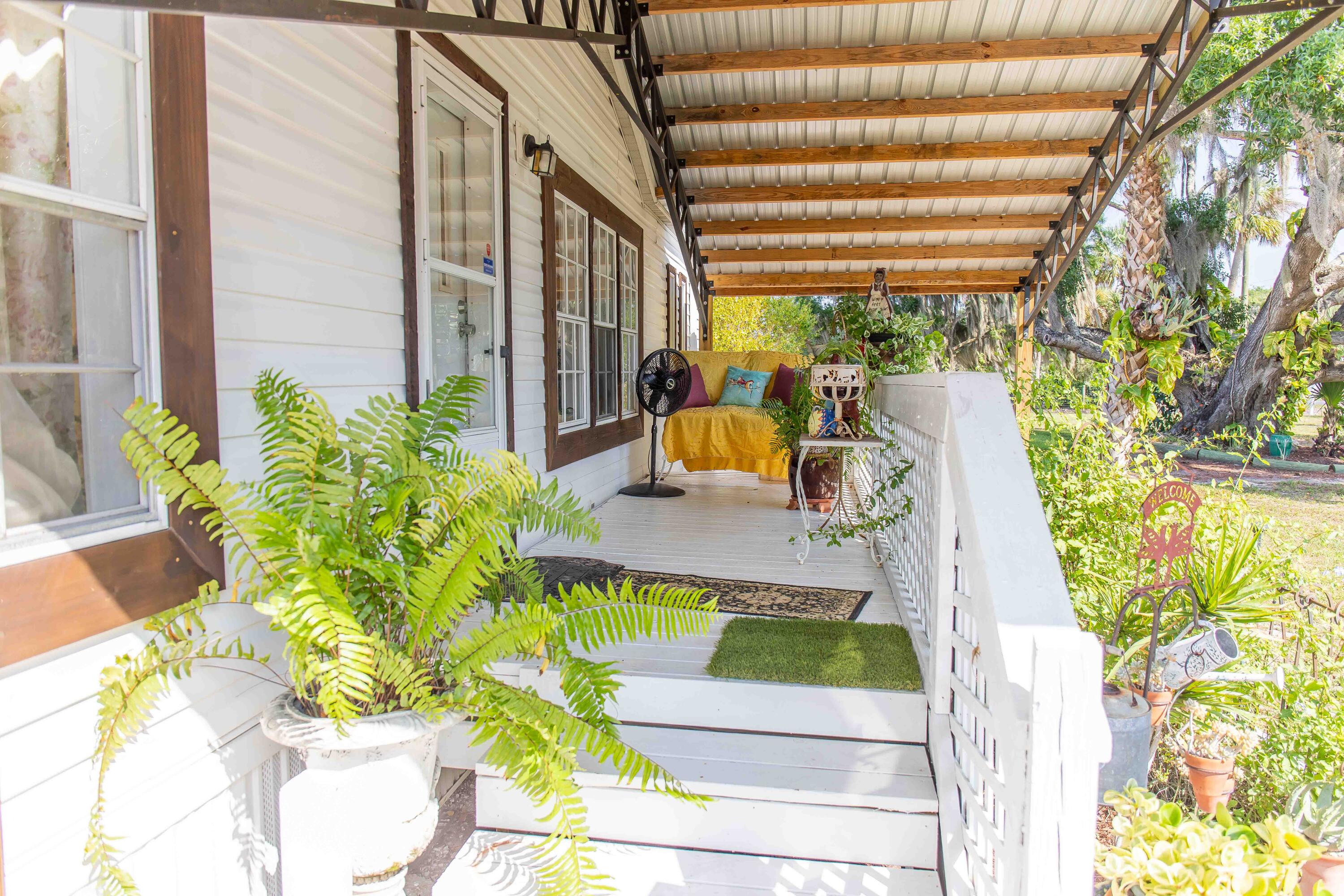 12302 Highway 441 Okeechobee, FL 34974 - Photo 10 of 63 a view of a porch with chairs and a potted plant