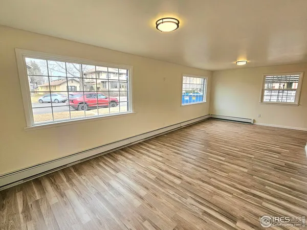 a view of a room with wooden floor and brick walls