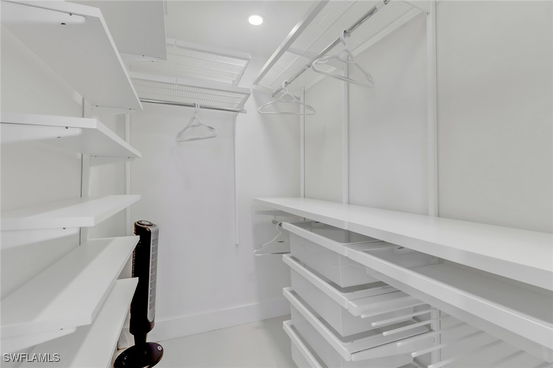 9 High Point Circle North, Unit 102 Naples, FL 34103 - Photo 16 of 48 a bathroom with a sink and a vanity