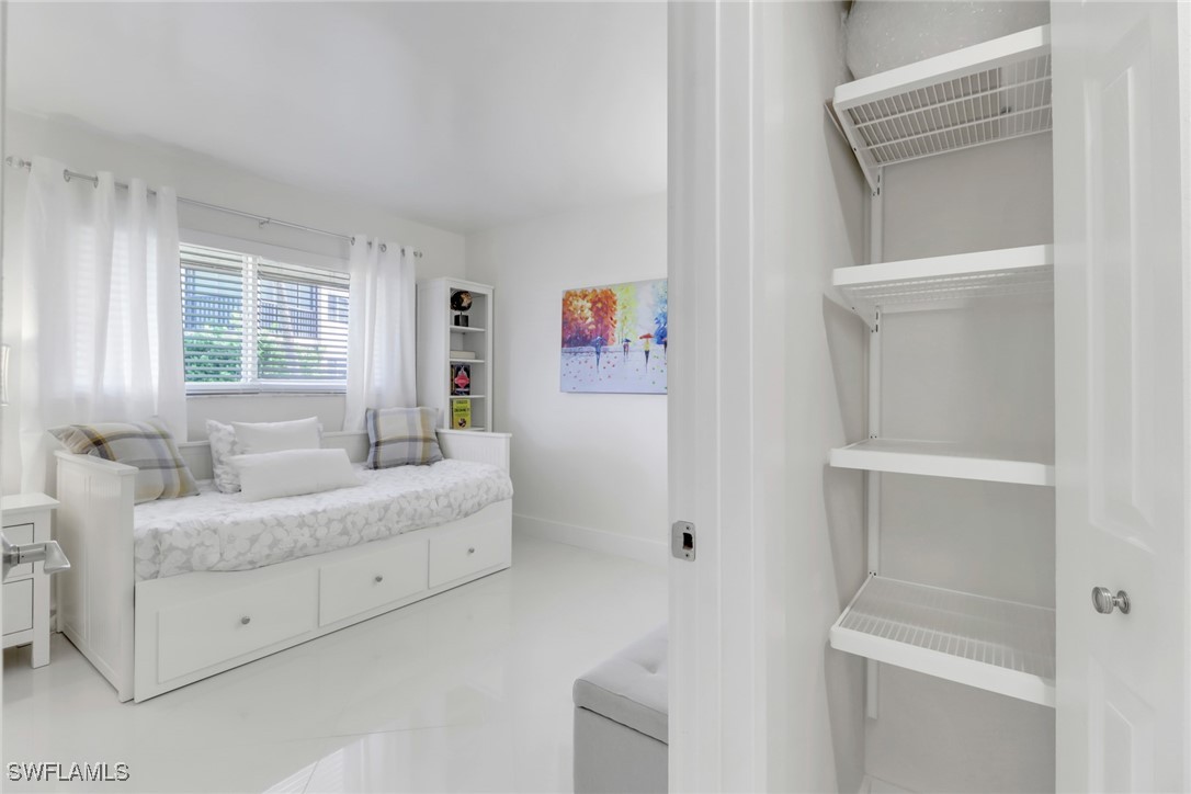 9 High Point Circle North, Unit 102 Naples, FL 34103 - Photo 19 of 48 a living room with furniture and a window