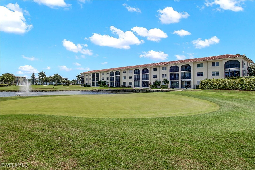 9 High Point Circle North, Unit 102 Naples, FL 34103 - Photo 32 of 48 a view of a house with a big yard