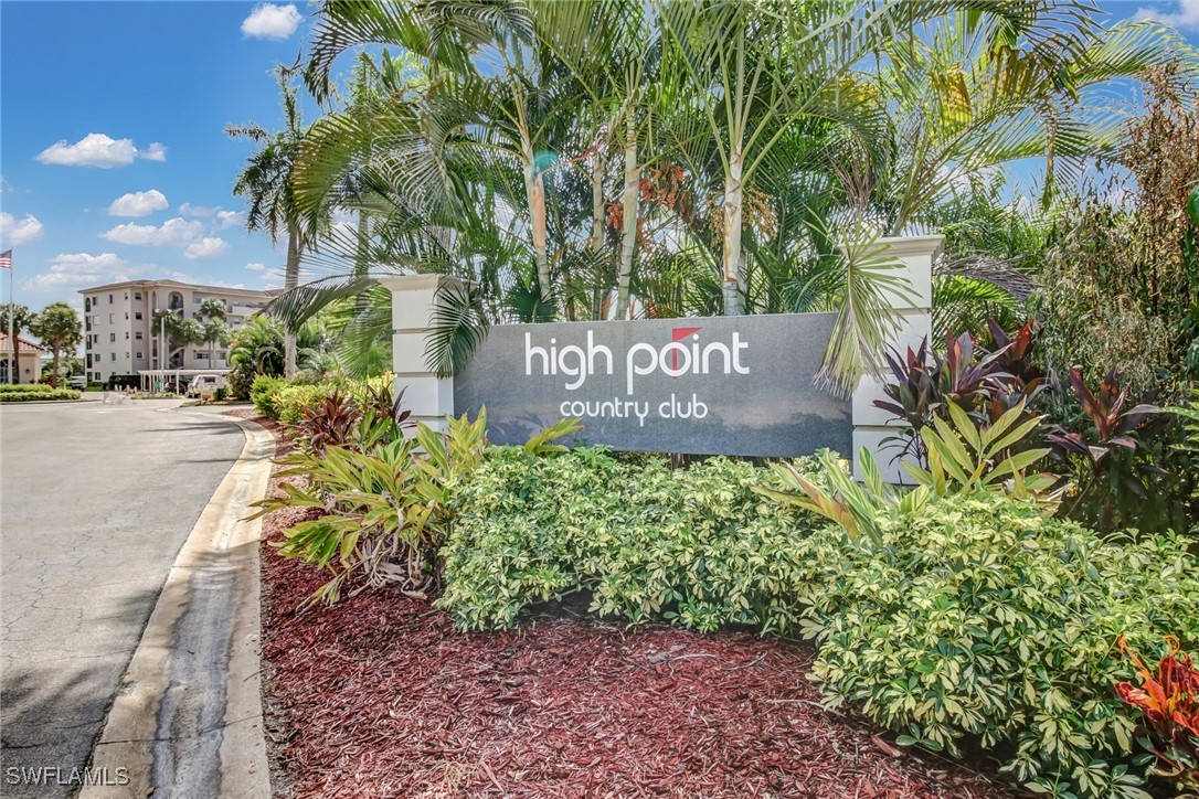9 High Point Circle North, Unit 102 Naples, FL 34103 - Photo 34 of 48 a sign that is sitting in front of flowers