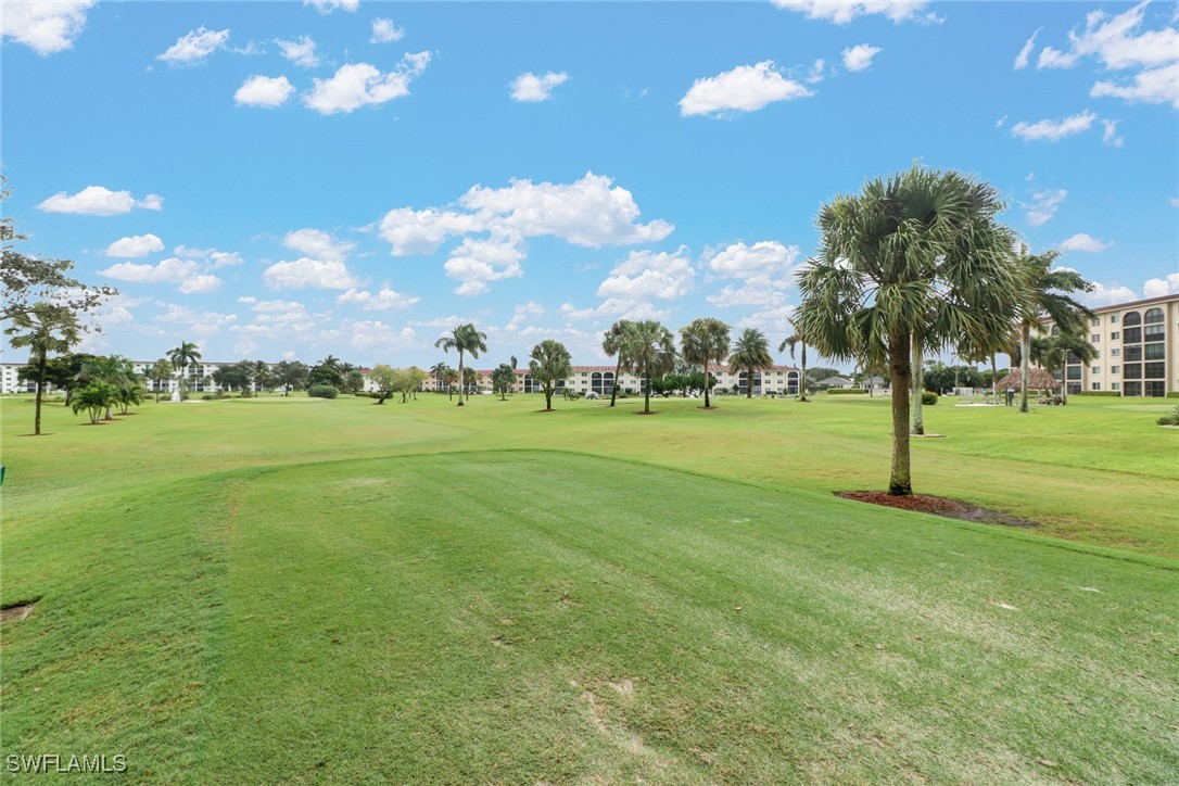 9 High Point Circle North, Unit 102 Naples, FL 34103 - Photo 39 of 48 a view of a golf course with a big yard