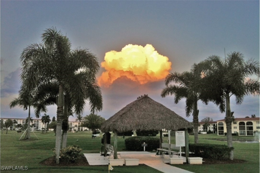 9 High Point Circle North, Unit 102 Naples, FL 34103 - Photo 43 of 48 a front view of a house with garden
