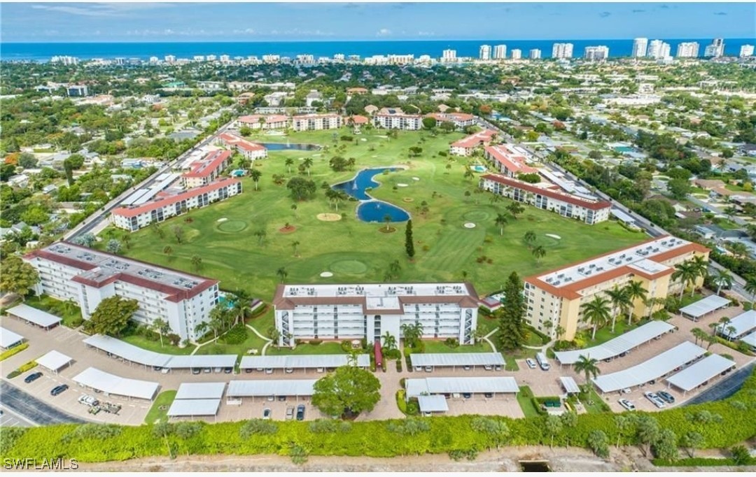 9 High Point Circle North, Unit 102 Naples, FL 34103 - Photo 44 of 48 an aerial view of residential houses with outdoor space and street view