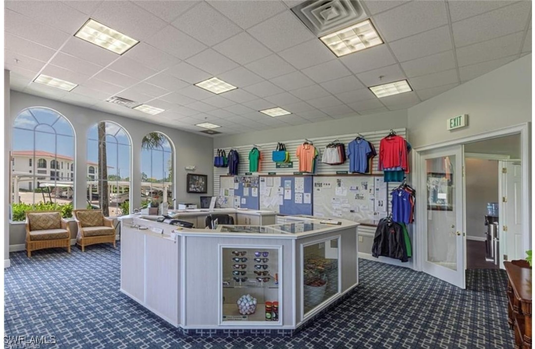 9 High Point Circle North, Unit 102 Naples, FL 34103 - Photo 46 of 48 a living room with furniture a flat screen tv and a rug