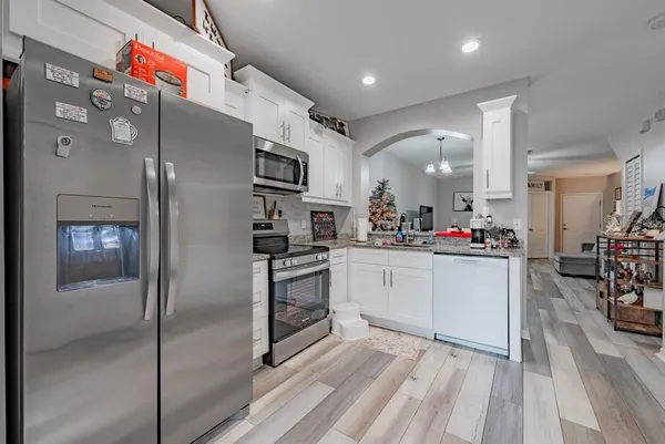 a kitchen with stainless steel appliances a refrigerator sink and cabinets