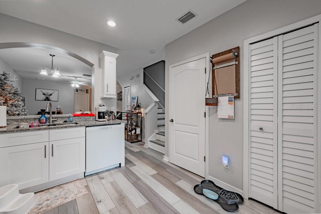 15856 Fishhawk View Drive Lithia, FL 33547 - Photo 15 of 31 a large white kitchen with a sink and dishwasher a stove with wooden floor