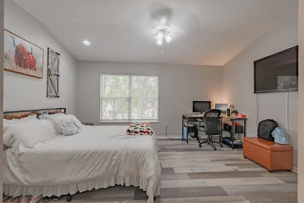 a bedroom with a bed and a flat screen tv