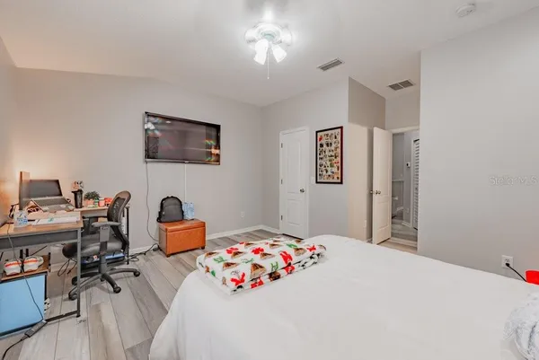 a bedroom with a bed and a desk