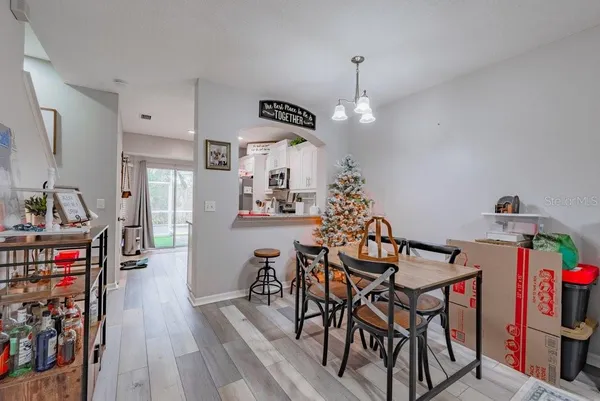 a view of a dining room with furniture and wooden floor