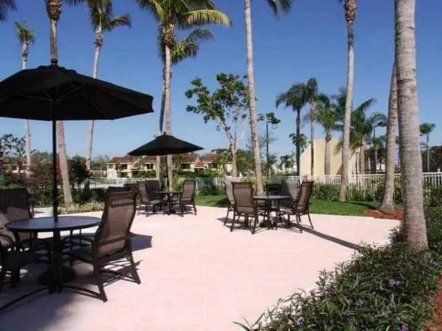 an outdoor space with patio and white umbrellas