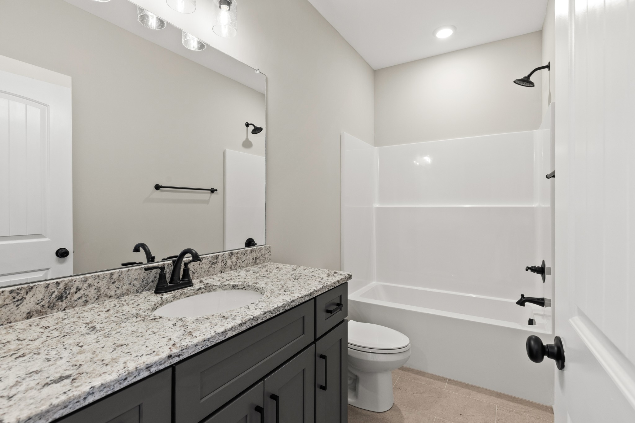 5638 Borthick Road Springfield, TN 37172 - Photo 29 of 43 a bathroom with a granite countertop sink a toilet and shower