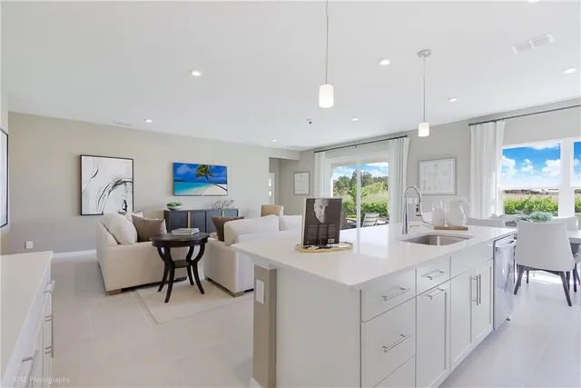 a kitchen with sink and white cabinets