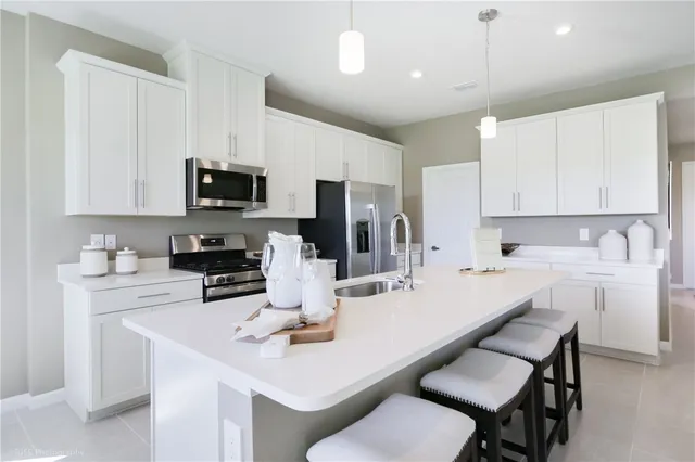 a kitchen with a sink stove and microwave