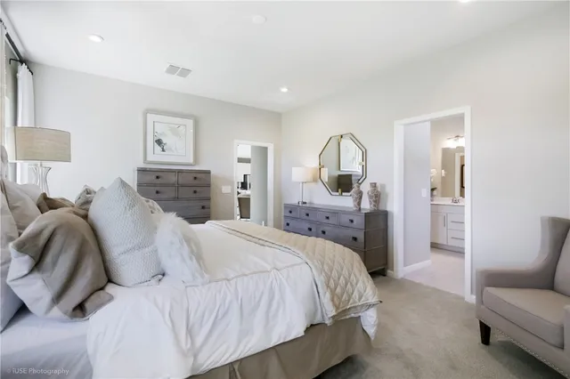 a bedroom with a bed a couch and dresser