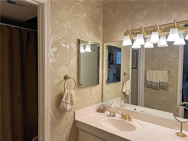 a bathroom with a sink and mirror