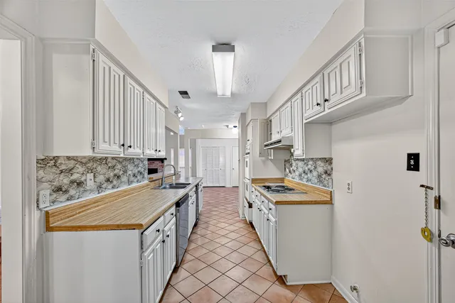 a kitchen that has a sink and a stove