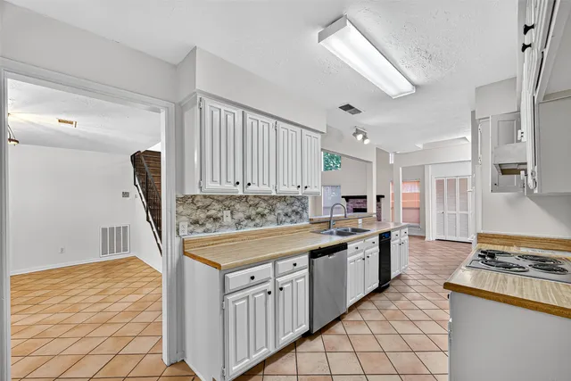 a kitchen with stainless steel appliances granite countertop a stove and a sink