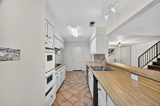 a kitchen with a stove and a sink