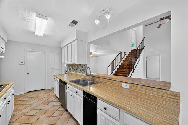 a kitchen with stainless steel appliances granite countertop a stove and a sink