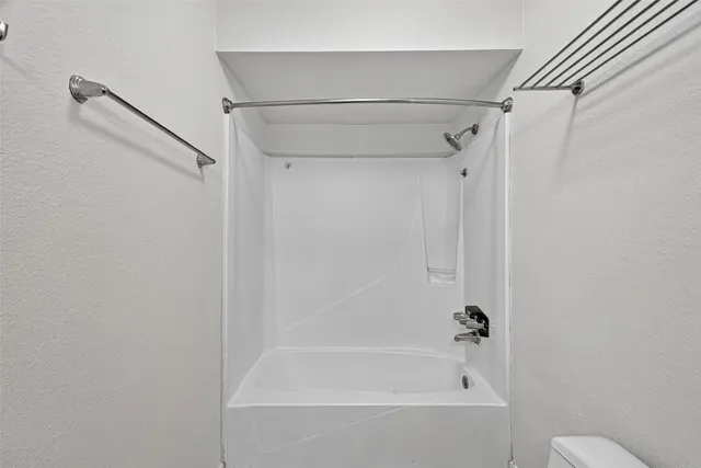 a view of a yard with wooden fence