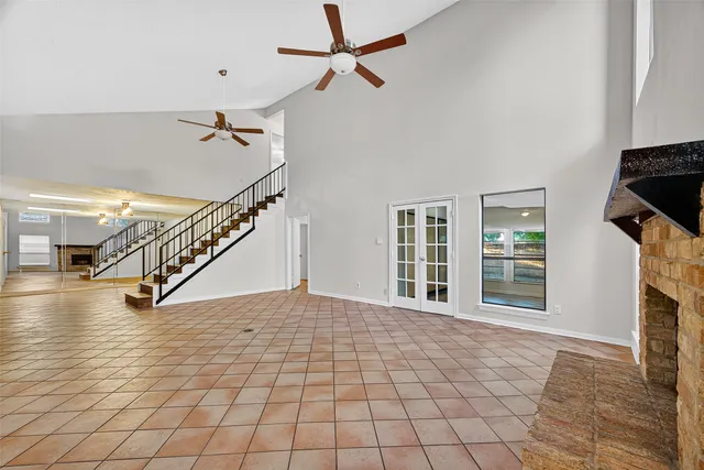 a view of empty room with fireplace and fan