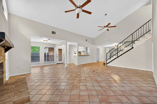 a view interior of a house with wooden floor windows and a ceiling fan