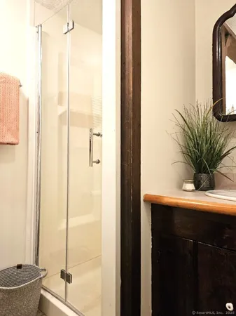 a view of bathroom with a shower and a tub