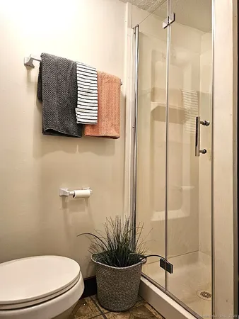 a bathroom with a toilet and a shower