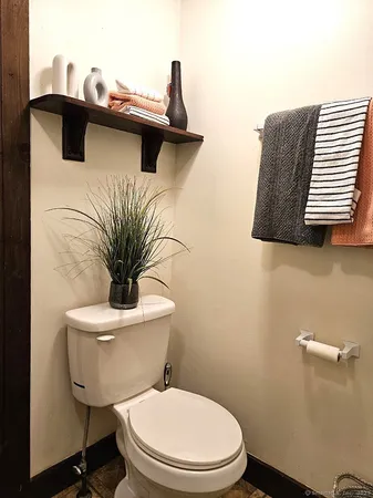 a white toilet sitting next to a bathroom sink