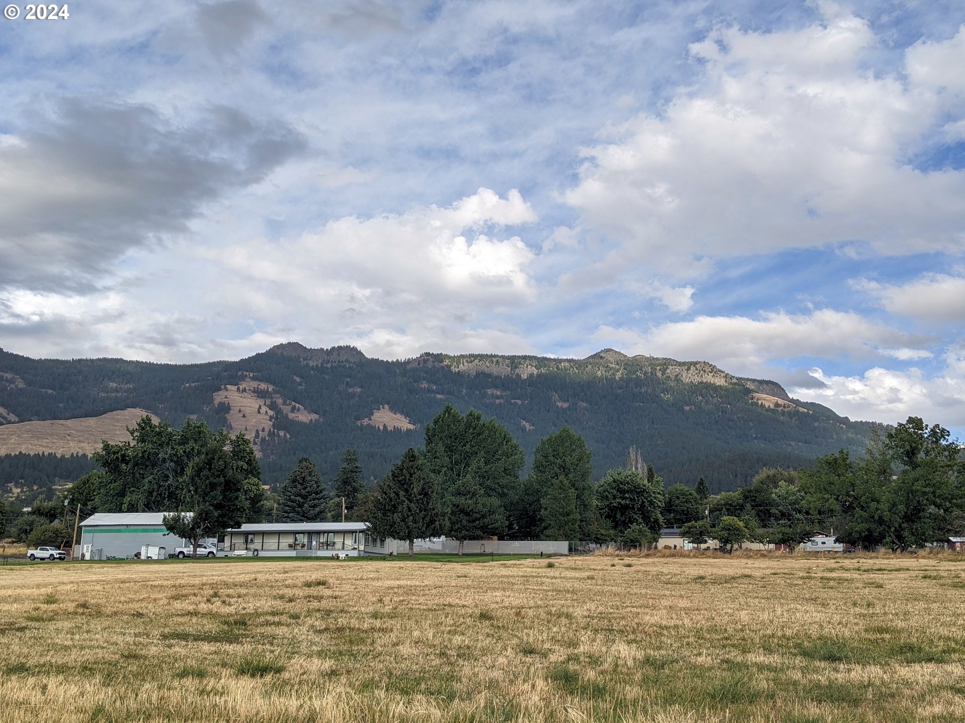 Antles Cove, OR 97824 - Photo 3 of 4 a view of a swimming pool with mountains in the background