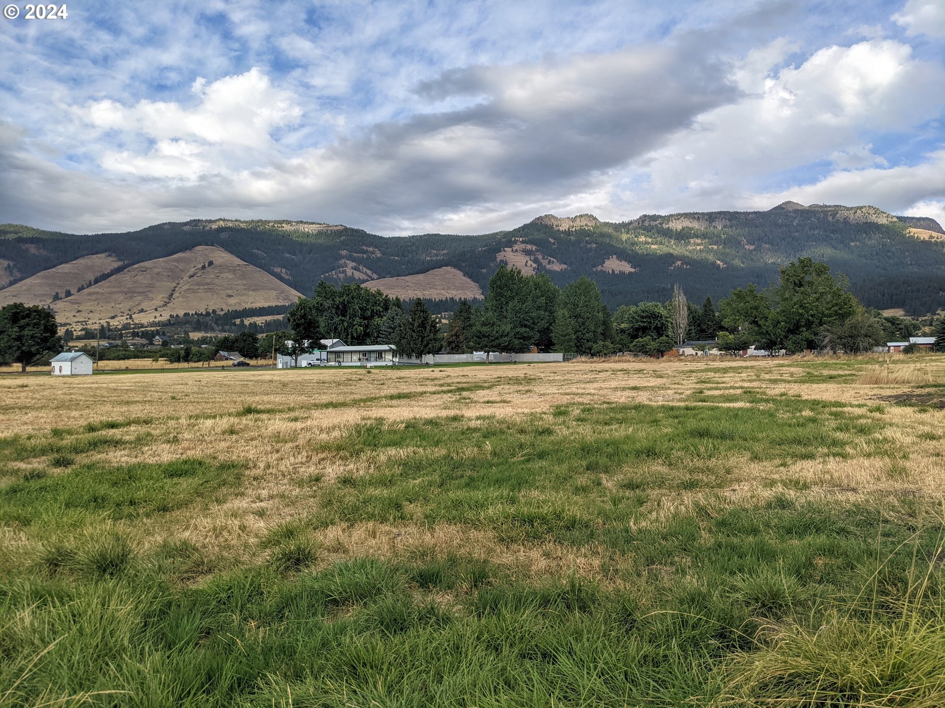 Antles Cove, OR 97824 - Photo 4 of 4 a view of a town with mountains in the background