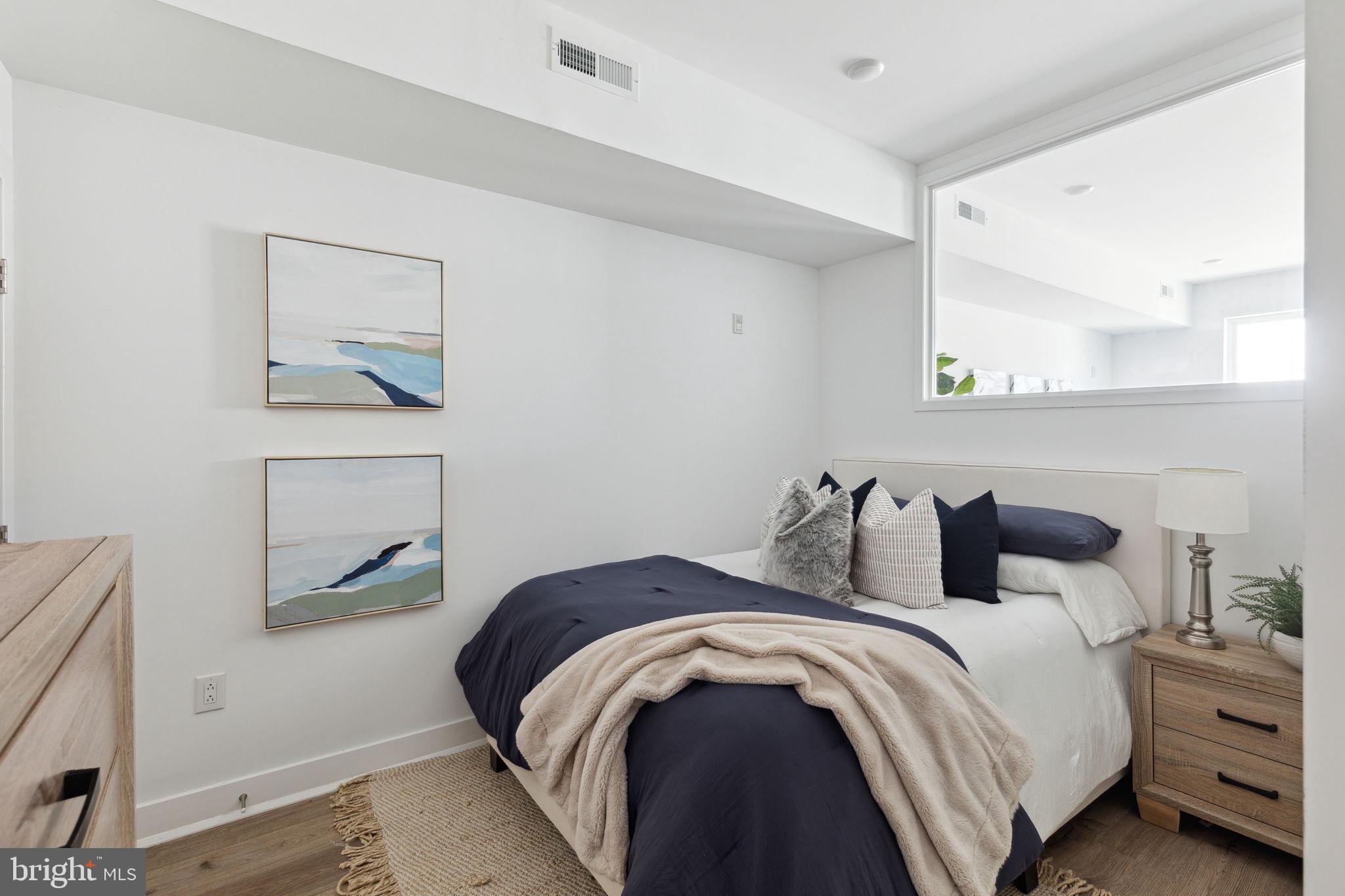 1439 Federal Street, Unit 211 Philadelphia, PA 19146 - Photo 11 of 21 a bedroom with a bed and a window