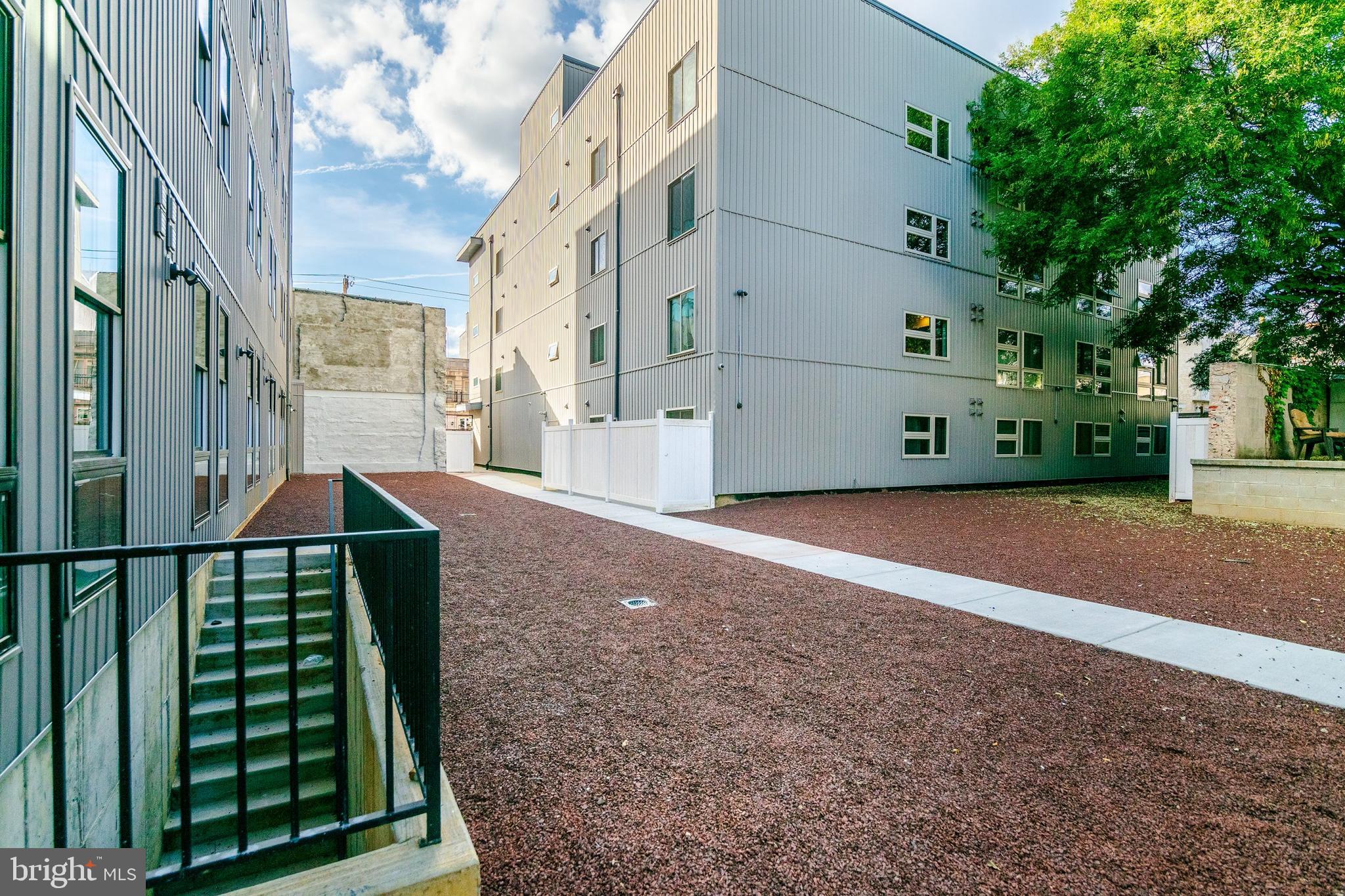 1439 Federal Street, Unit 211 Philadelphia, PA 19146 - Photo 16 of 21 a backyard of a house with lots of green space