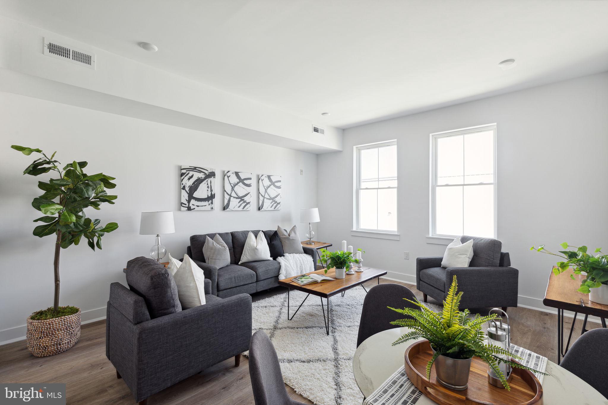 1439 Federal Street, Unit 211 Philadelphia, PA 19146 - Photo 2 of 21 a living room with furniture potted plant and a window