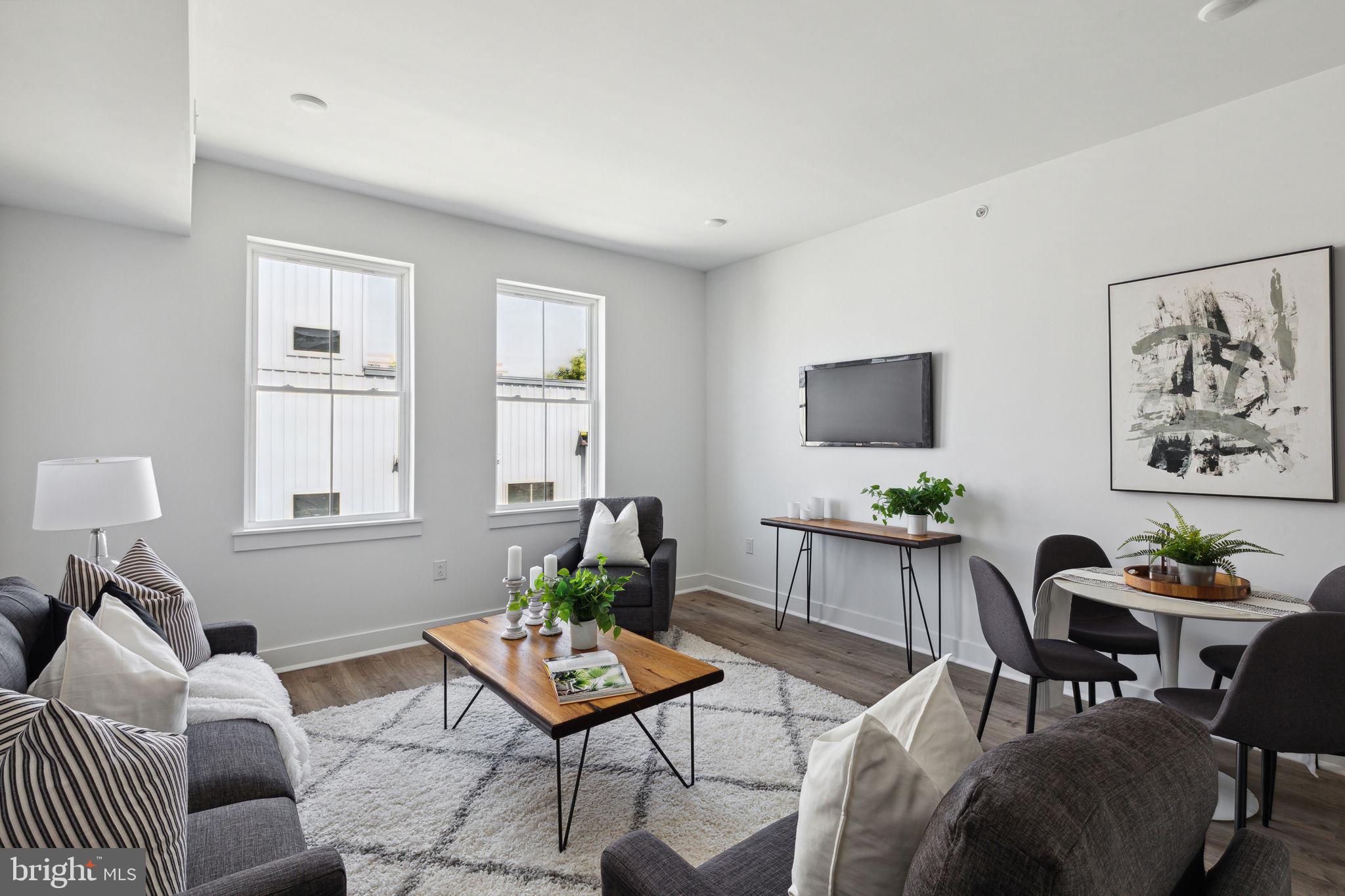 1439 Federal Street, Unit 211 Philadelphia, PA 19146 - Photo 3 of 21 a living room with furniture and wooden floor