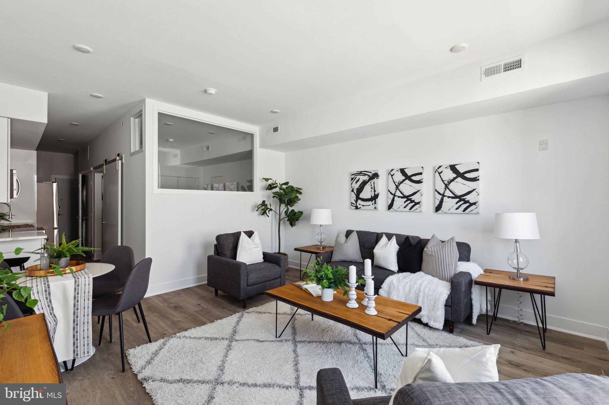1439 Federal Street, Unit 211 Philadelphia, PA 19146 - Photo 5 of 21 a living room with furniture and wooden floor