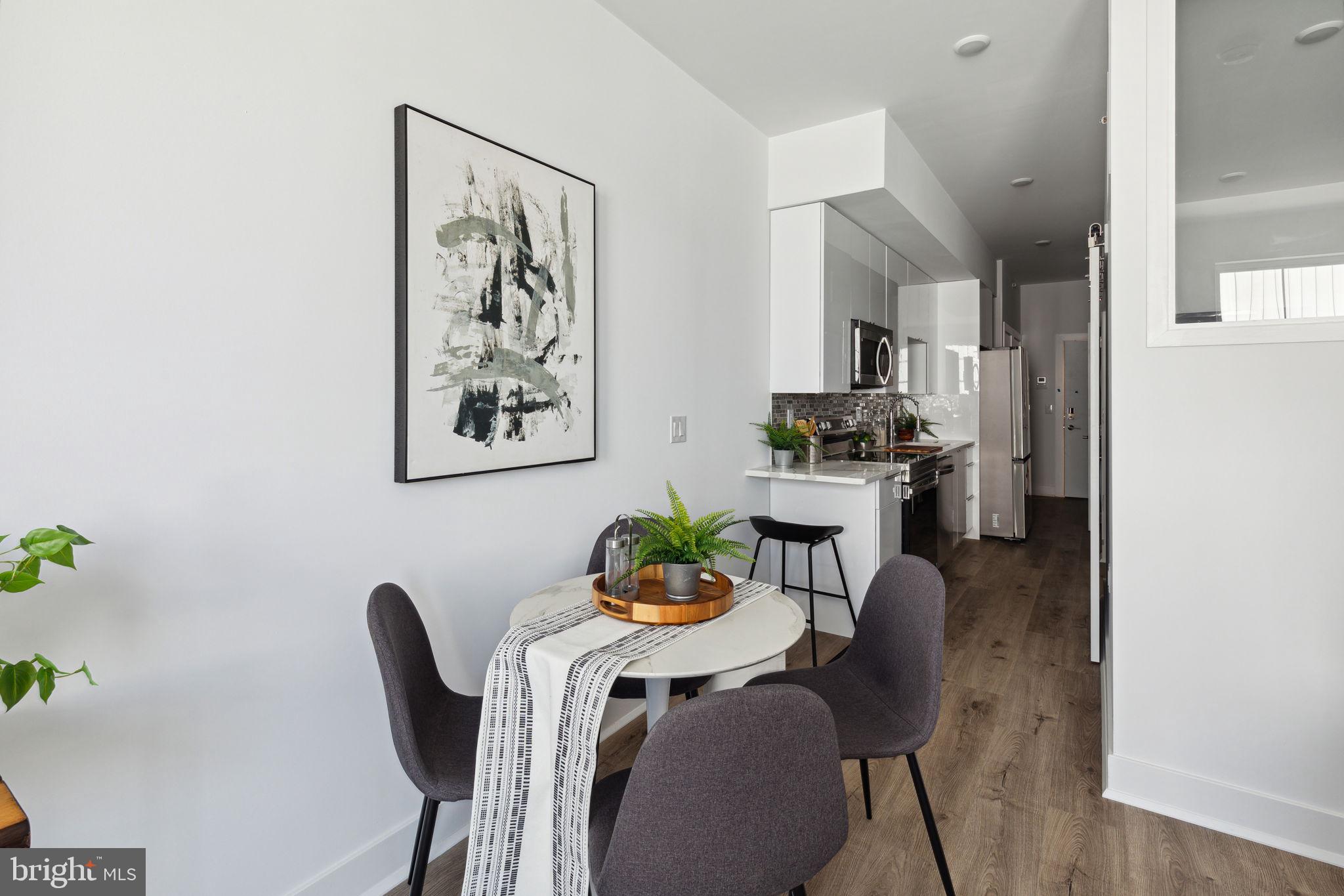 1439 Federal Street, Unit 211 Philadelphia, PA 19146 - Photo 6 of 21 a dining room with furniture and window